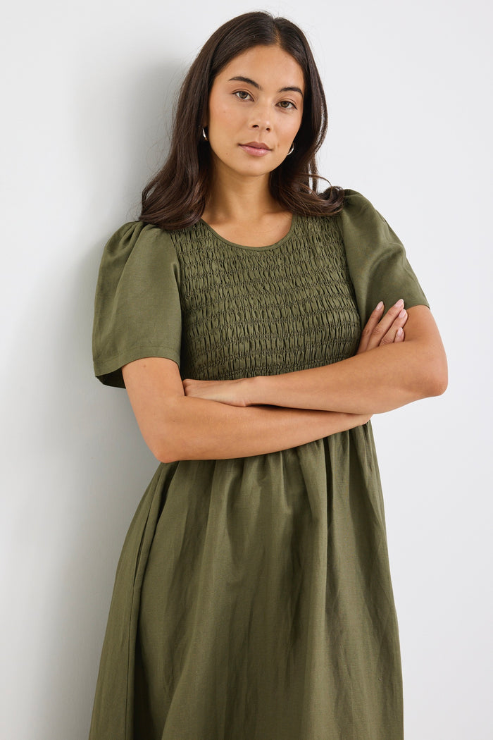 model wears a khaki linen midi dress
