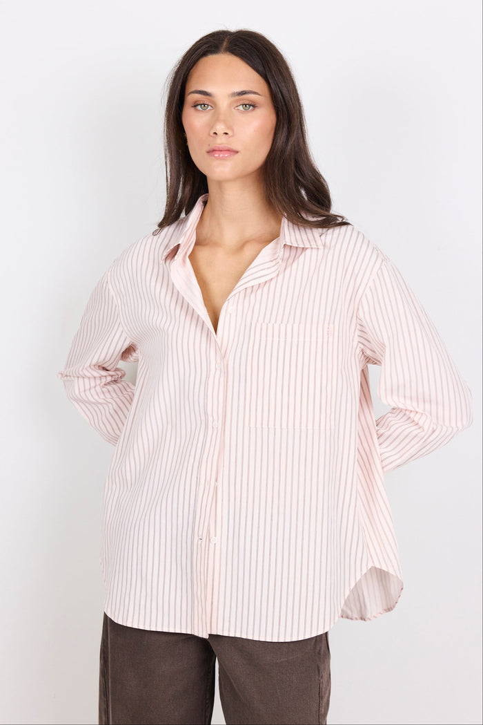Woman wearing a striped shirt against a white background