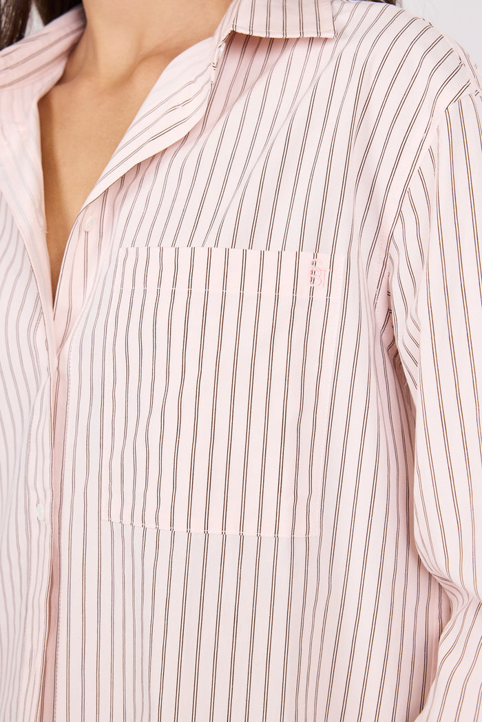 Close-up of a person wearing a light pink and white striped shirt.
col_pattern