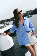 model wearing blue and white stripe shirt with shorts