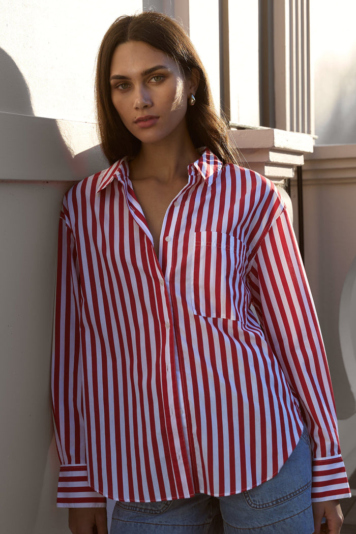 model wears red striped shirt