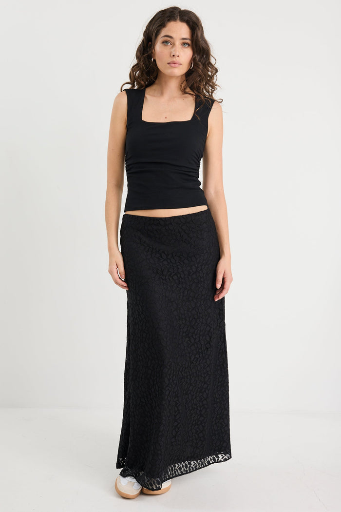 Model wearing a black lace skirt and black tank