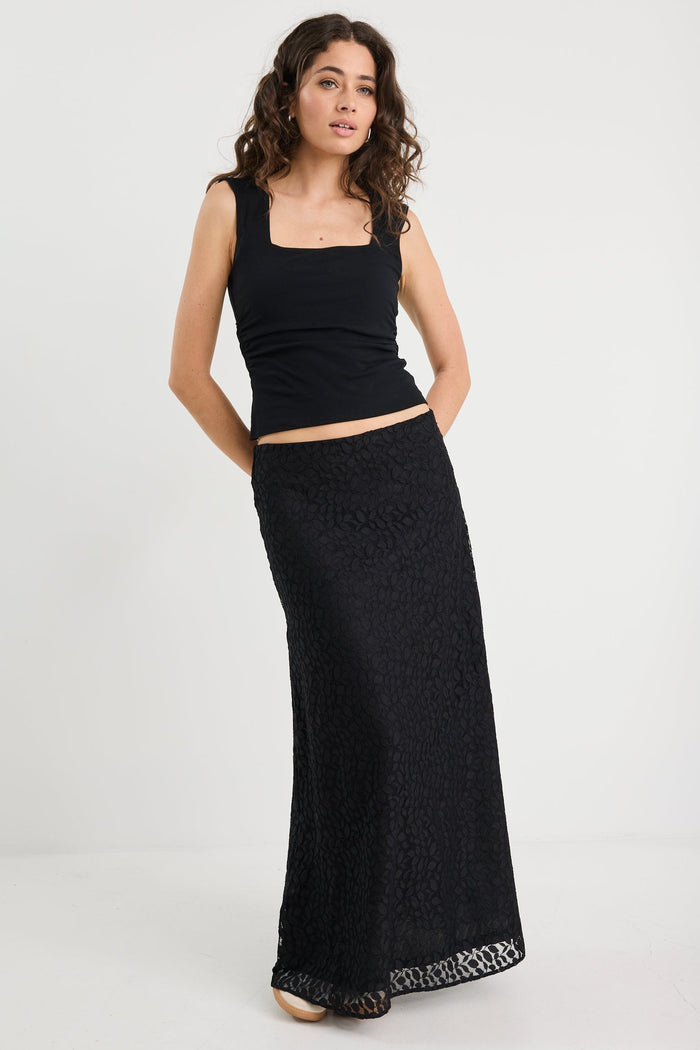 Woman wearing a black lace skirt and black tank