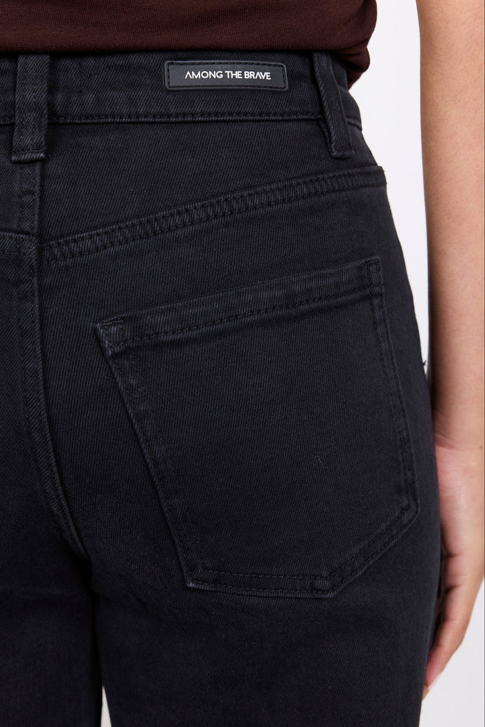Black pants with a brand label on a white background