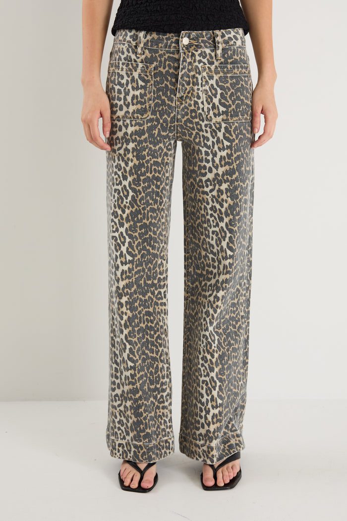model wearing animal print jeans and a black top