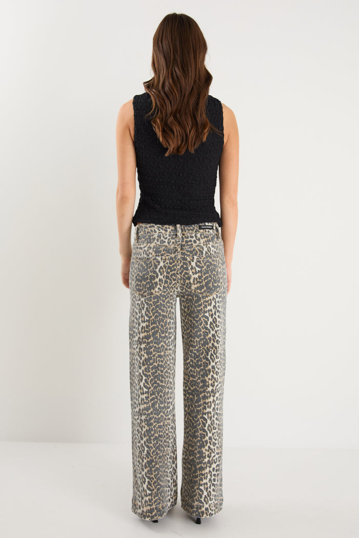 model wearing animal print jeans and a black top