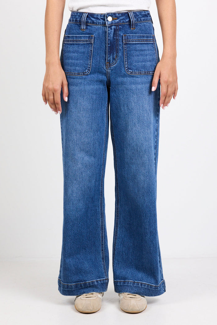 Person wearing blue jeans on a white background