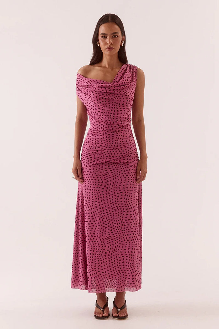 Woman wearing a pink polka dot dress on a white background